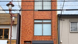 A two-story building with a brick facade, a wooden door, and a sign that reads 'Nakatani'. - The House Nagoya 5DK (Nakata, Chikusa-ku, Nagoya-shi)