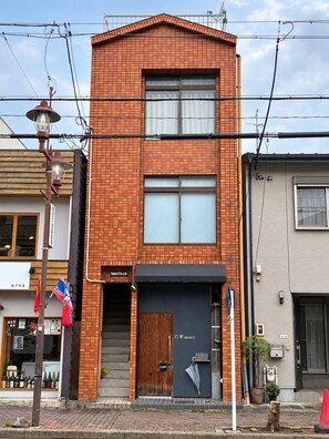A two-story building with a brick facade, a wooden door, and a sign that reads 'Nakatani'. - The House Nagoya 5DK (Nakata, Chikusa-ku, Nagoya-shi)