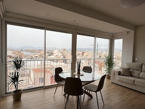 A spacious living room with a balcony, a dining area, and a sofa. - A LUXURIOUS AND COMFORTABLE OASIS WITH OCEAN VIEWS (Aguilas)