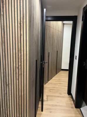A hallway with wooden paneling and a black door. - A LUXURIOUS AND COMFORTABLE OASIS WITH OCEAN VIEWS (Aguilas)