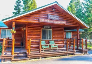 A wooden lodge with a sign indicating it's managed by Trading Places International. - 2BR Spacious Condo w/ Full Kitchen (Island Park)