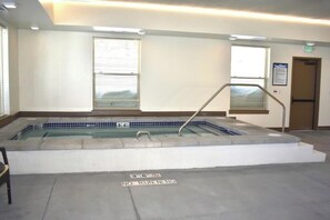 A hot tub with a no running sign, a window, and a door. - 2BR Spacious Condo w/ Full Kitchen (Island Park)