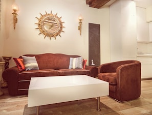 A living room with a sofa, armchair, and a coffee table.