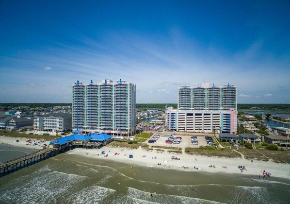 A coastal hotel with multiple high-rise buildings, a beach, and a pier. - Prince Resort 2BR Ocean View (North Myrtle Beach)