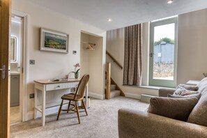 A room with a desk, chair, and a window with a view of a building outside. - Billy Goats Gruff - Bakewell , Derbyshire (Bakewell)