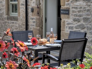 An outdoor dining table with chairs, a bottle of wine, and a loaf of bread. - Billy Goats Gruff - Bakewell , Derbyshire (Bakewell)