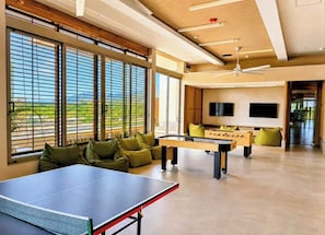 A spacious living area with a ping pong table, foosball table, and comfortable seating. - Luxury Sky Retreat / Rooftop with Ocean View (Santa Marta City)