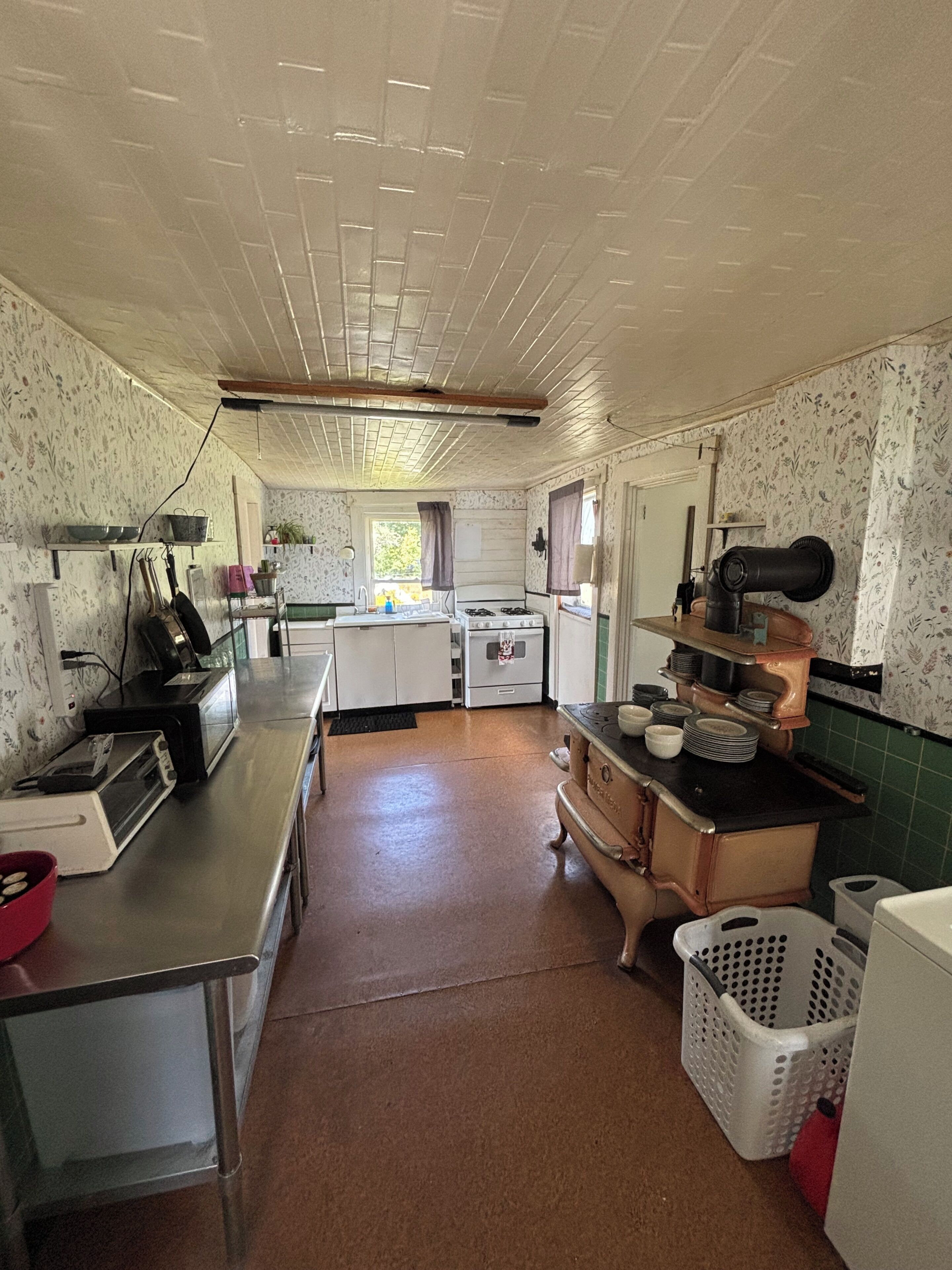 A kitchen with a stove, sink, and various appliances.