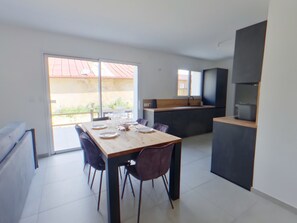 A modern kitchen with a dark countertop and a built-in oven. - Modern apartment, serene nature - 6 guests (Les Rousses)
