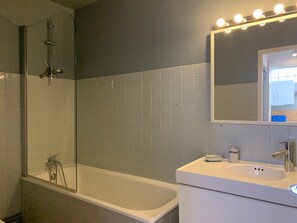 A bathroom with a glass-enclosed shower, a white bathtub, and a sink with a mirror above it. - Apartment with large terrace - 4 guests (Pra-Loup)