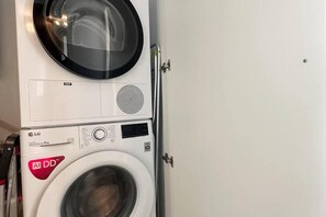 A stacked washer and dryer unit with visible control panels and brand logos.