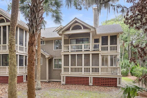 A multi-story house with a balcony, a garage, and a large yard. - Anchor Down - 2 Bed Beach Fun Dining Golf (Seabrook Island)