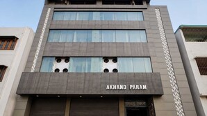 A modern building with a sign reading 'AKHAND PARAM' above the entrance.