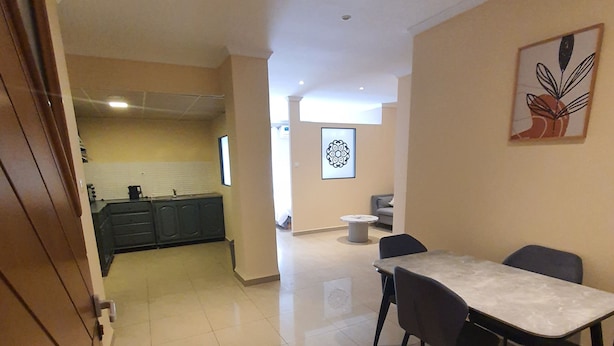A spacious kitchen with modern appliances and a dining area with a table and chairs.
