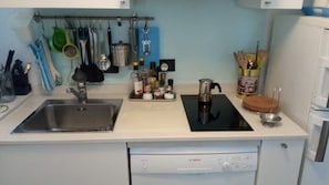 A kitchen with a Bosch dishwasher, a sink, and a stove.