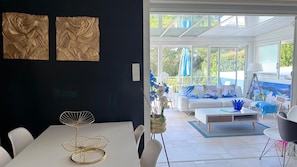 Een modern interieur met een eethoek, een bank en uitzicht op het landschap.