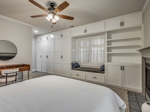 A bedroom with a bed, a desk, a chair, a wardrobe, and a ceiling fan. - This charming 1920s fully updated home is perfectly located in the OKC area. (Moore)