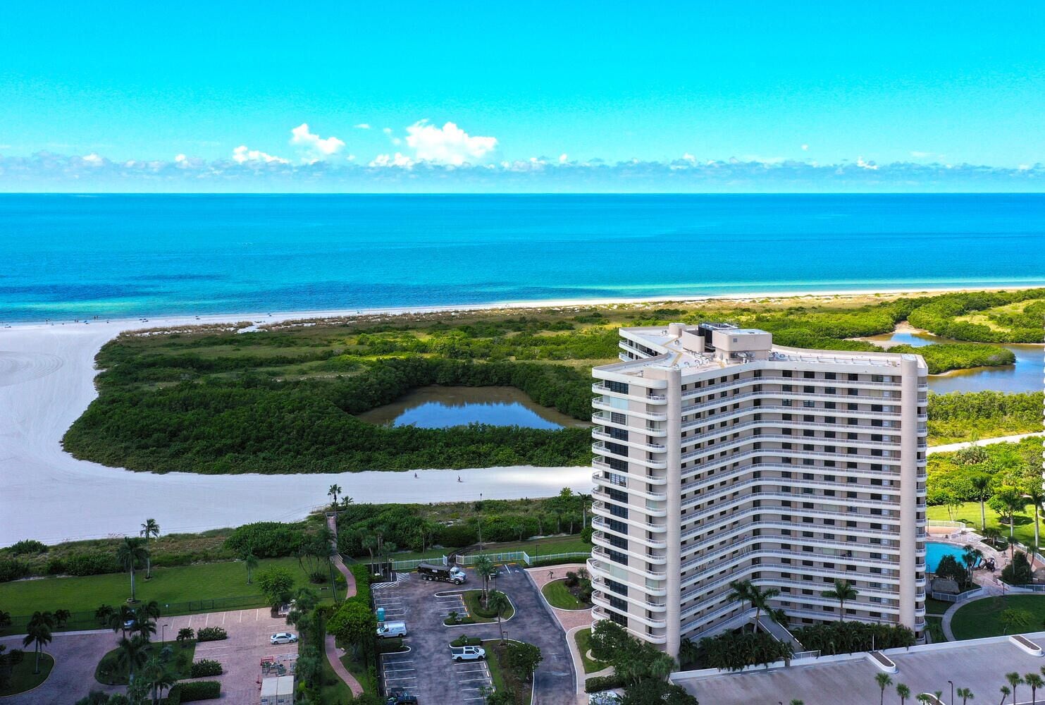 Een hoog hotel met uitzicht op zee en een strand.