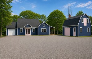 A two-story house with a garage, a covered porch, and a driveway. - Marvelous 2-bedroom house in charming Damariscotta awaits you (Damariscotta)