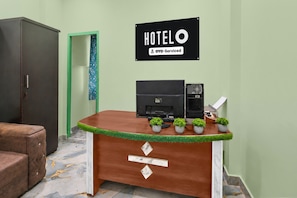 A reception desk with a sign that reads 'HOTEL' and 'OYO-Serviced'. - Classic Ramoji Film City (Hyderabad)