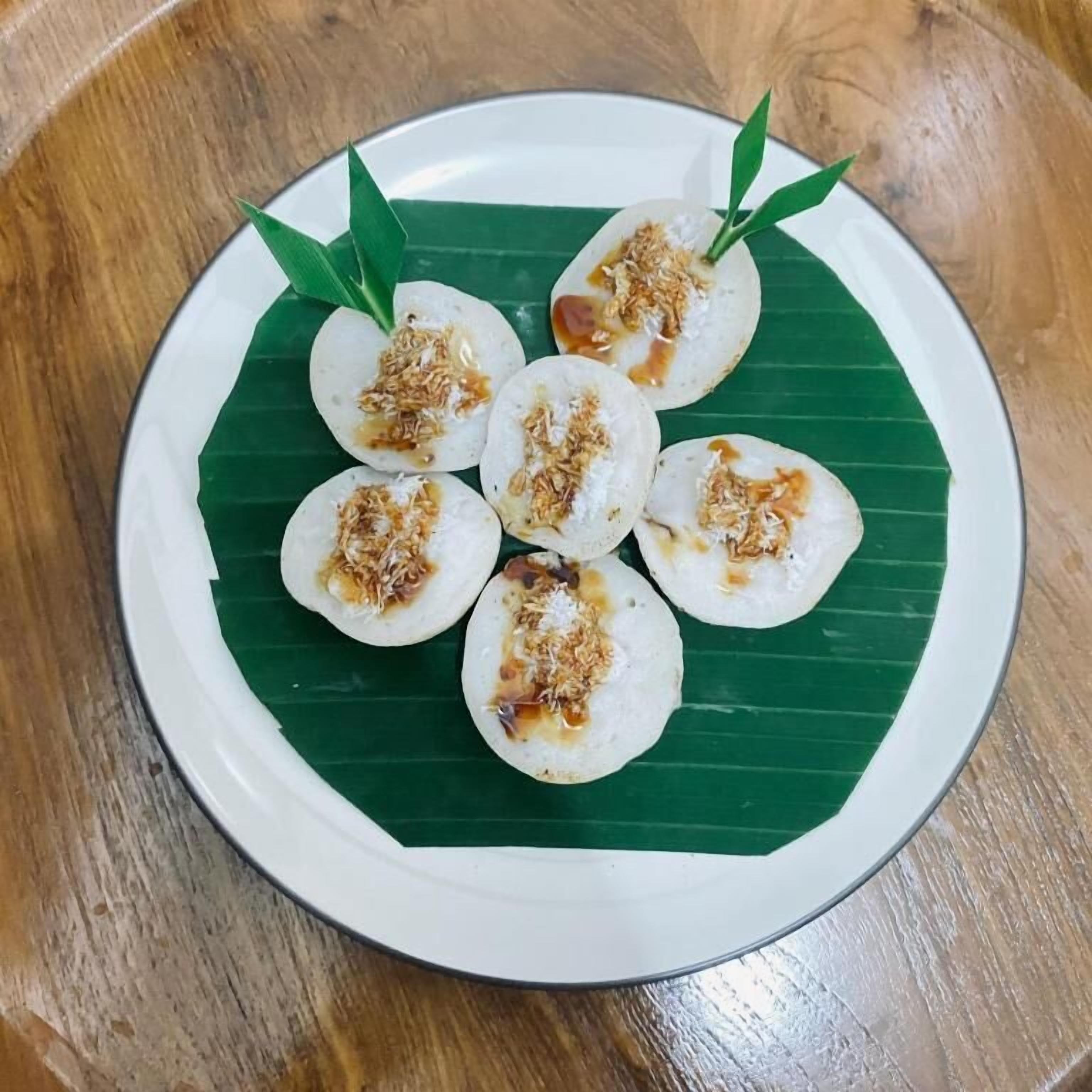 A plate of food with a green leaf base.