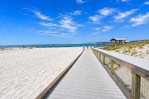 A beach with a wooden boardwalk leading to a beach hut. - Waterview Towers 104 Harbor Views & Resort Living & Boat Slip Option Sleeps 8 (Destin)