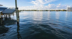 A calm waterfront with boats docked, a clear sky, and buildings in the background. - Waterview Towers 104 Harbor Views & Resort Living & Boat Slip Option Sleeps 8 (Destin)
