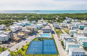 A residential area with multiple houses, a swimming pool, and a basketball court. - Paradise Found~ Oceanfront Home in Key Largo, FL (Key Largo)