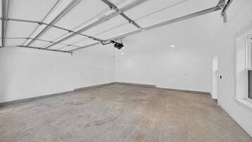 A spacious, empty room with a high ceiling and visible ductwork.