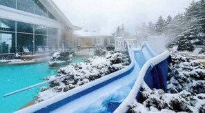 A snow-covered outdoor area with a pool, a slide, and lounge chairs. - The Summit at 4848-3 Bedrooms, Steps to the Snowshoe Village and Slopes! (Snowshoe)