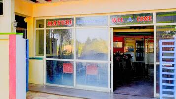 A family restaurant with a sign that reads 'MAYURI FAMILY RESTAURANT' and a separate sign for 'MAYURI COMECE'.