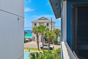 A view of a building with a white facade and a balcony. - Lakeview #9 - Paradise By The Gulf (Miramar Beach)