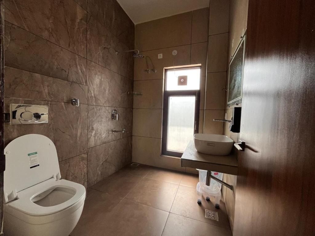 A bathroom with a toilet, a sink, and a shower.
