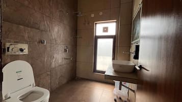 A bathroom with a toilet, a sink, and a shower.