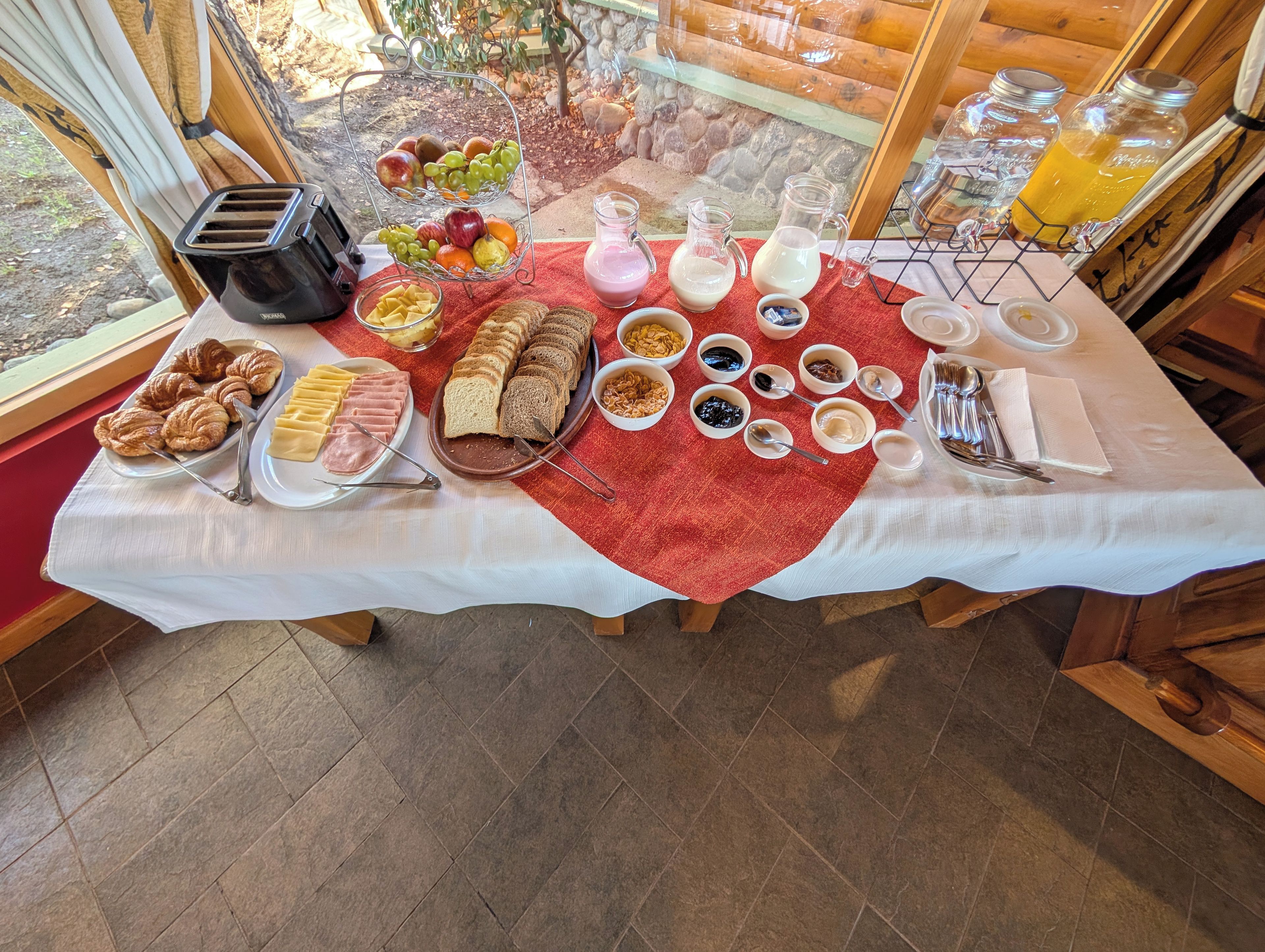 A breakfast buffet with various food items and beverages.