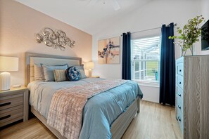 A bedroom with a bed, bedside tables, a dresser, and a window with curtains. - Luxury 4 br Golf Villa, Minutes to Disney, pool (Davenport)