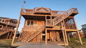 A multi-level wooden structure with balconies and staircases. - Pet-Friendly Soundfront Retreat with Private Dock & Incredible Sunsets. (Avon)