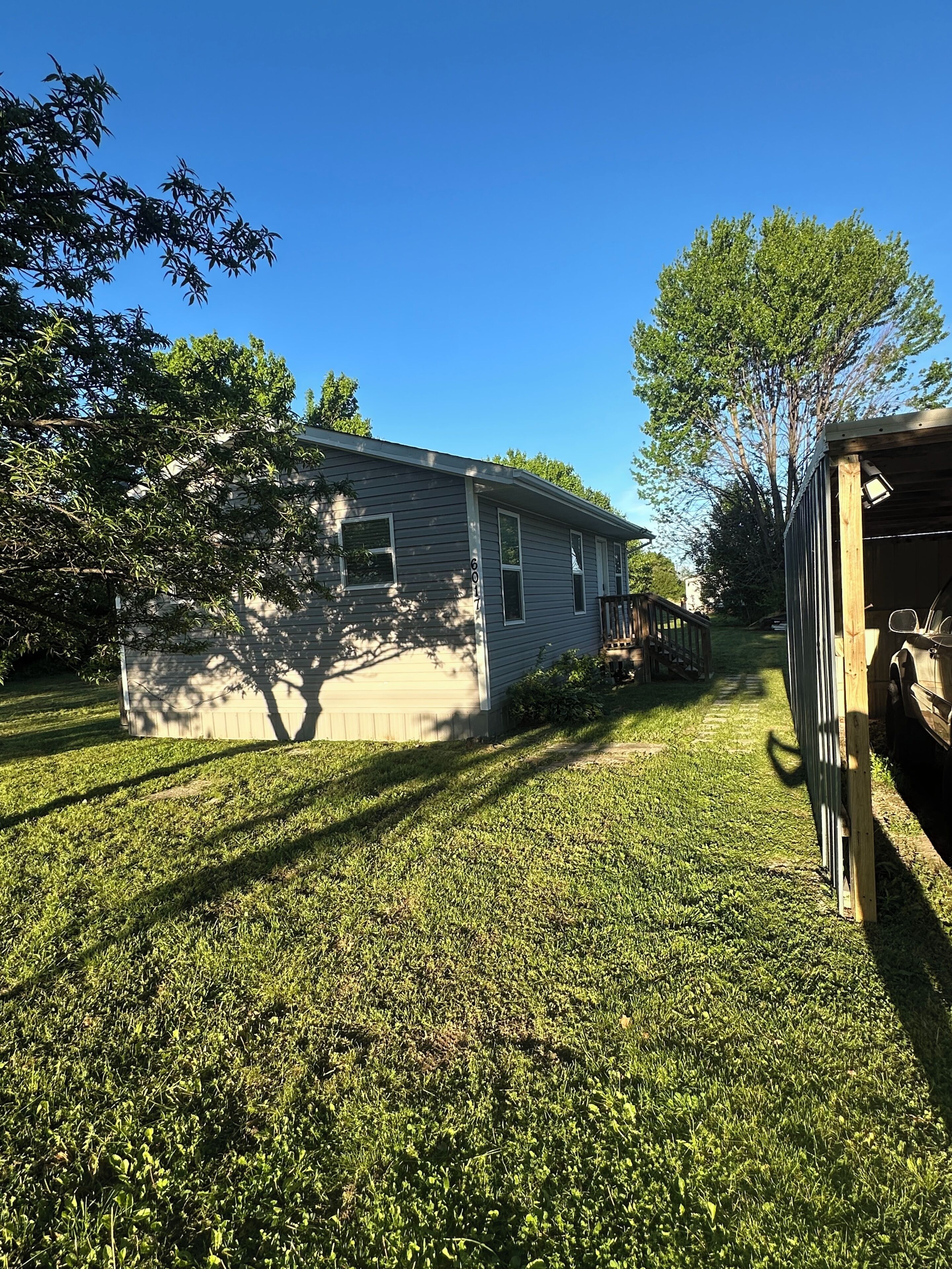 A residential property with a house, a garage, and a well-maintained lawn.