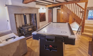 A room with a pool table, a fireplace, and a wooden staircase. - Peak District Country Escape - Garden, Views, Games & Fire (Combs)