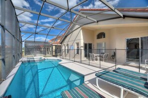 A pool area with a glass roof, outdoor seating, and a covered patio. - Casa Sevilla | 4 BD | Sleeps 8 | Pool/Spa | Disney (Davenport)