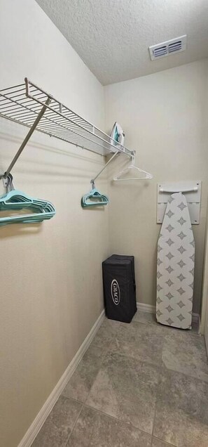 A laundry area with a drying rack, a bag, and a towel rack. - Solterra 5BD•Sleeps13•Private Pool•Disney•Resort (Davenport)