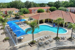 Ein Resort mit Pool, Liegestühlen und einer überdachten Sitzgruppe.
