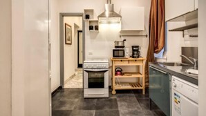 A compact kitchen with a stove, microwave, and dishwasher. - CRISPI HOLIDAY IN (Roma)