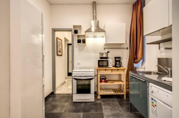 A compact kitchen with a stove, microwave, and dishwasher. - CRISPI HOLIDAY IN (Roma)
