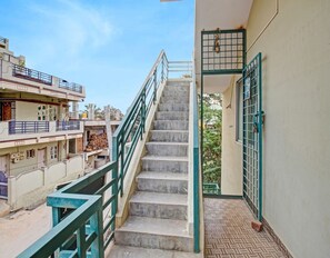 A staircase with metal railings leading to a building entrance.
