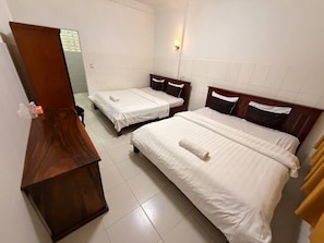 A hotel room with two single beds, a wooden dresser, and a mirror. - Lovely Bedroom bungalow with AC in Siem Reap (Siem Reap)