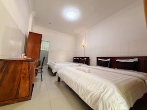 A hotel room with two single beds, a wooden desk, and a chair. - Lovely Bedroom bungalow with AC in Siem Reap (Siem Reap)