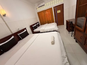 A hotel room with two beds, a wooden wardrobe, a desk, and a curtain. - Lovely Bedroom bungalow with AC in Siem Reap (Siem Reap)