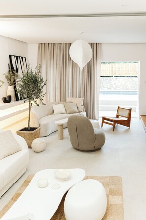 Una sala de estar moderna con un sofá, un sillón y una mesa de centro.