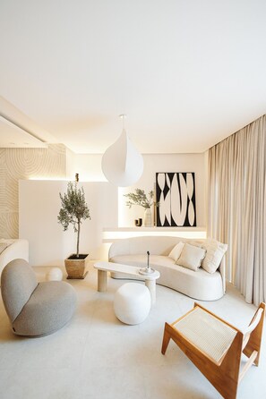 A modern living room with a sofa, a coffee table, a chair, and a potted plant. - Luxurious Villa Ksenia with Pool Murter (Murter)